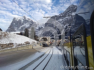Train entering the Grindelwald mountain train station Editorial Stock Photo