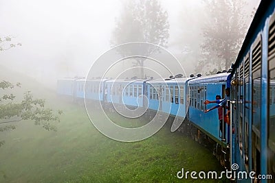 The train in the fog in the mountains of Sri Lanka. Surroundings Nuwara Eliya. Editorial Stock Photo