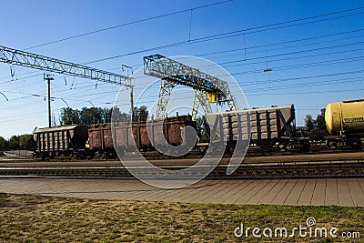 Train freight cars transport bulky goods, stop at the railway station Editorial Stock Photo