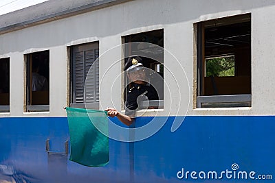 Train guard holding up a green flag Editorial Stock Photo