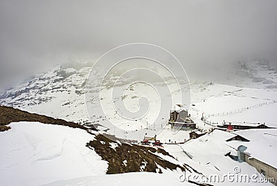 Train in Kleine Scheidegg under Eiger, Monch and Jungfrau peaks in Swiss Alps, Berner Oberland, Grindelwald, Editorial Stock Photo