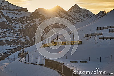 Train in Kleine Scheidegg under Eiger, Monch and Jungfrau peaks in Swiss Alps, Berner Oberland, Grindelwald, Editorial Stock Photo