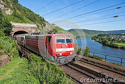 Train leaving tunnel near river Moselle in Germany Stock Photo