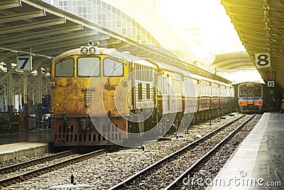 Train led by Old yellow Diesel Electric locomotives at Bangkok Railway Station Editorial Stock Photo