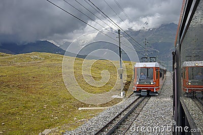 Train in motion and the Swiss Alps Mountains in background Editorial Stock Photo