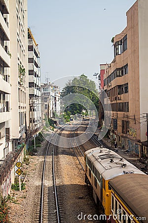 The train pass through the buildings in Bangkok Stock Photo