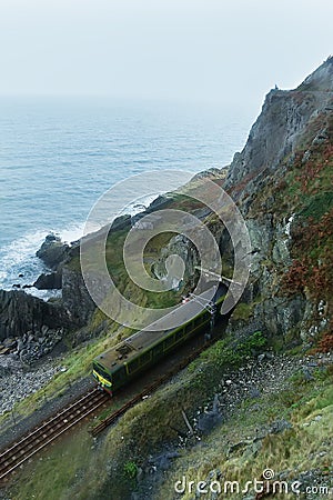 Train pass through railway track form mountain tunnel Stock Photo