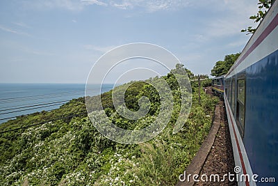 Train passes the sea, the hills, and jungle at the Hai Van Pass between Hue and Da Nang in Central Vietnam Stock Photo