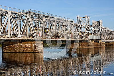 Train passing through an industrial railway bridge Stock Photo