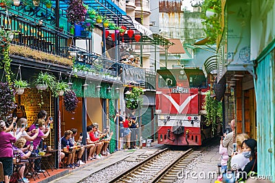 Train passing narrow road in old town in Hanoi Editorial Stock Photo