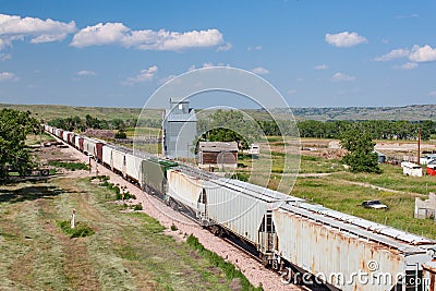 Train Passing Old Grain Elevator in South Dakota Stock Photo