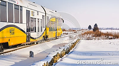 A train passing on a railroad on a winter day through a snowy landscape Editorial Stock Photo