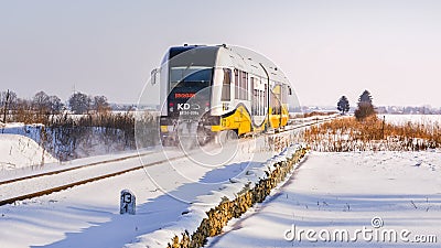 A train passing on a railroad on a winter day through a snowy landscape Editorial Stock Photo