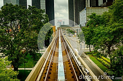 Train railway track between trees Editorial Stock Photo