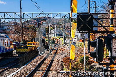 Train railway tracks junction with traffic light signal and engineer worker on inspection duty Editorial Stock Photo