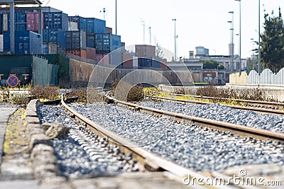 Train railways near the warehouse with a bunch of containers in the open air Stock Photo
