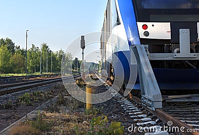 Train ready to be shipped stands on rails leaving far beyond the horizon, on a summer morning Stock Photo