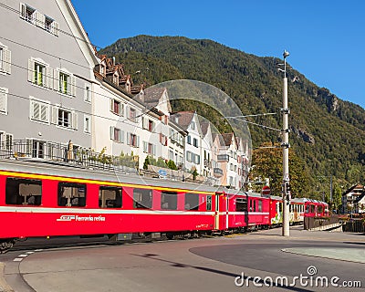 Train of the Rhaetian Railway passing along a street in the city of Chur, Switzerland Editorial Stock Photo