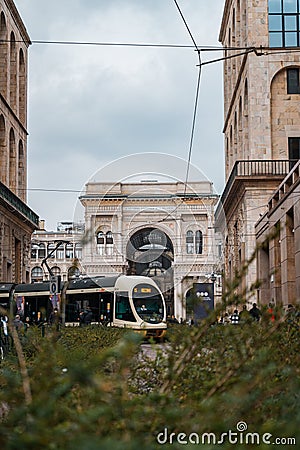 Train rolling through green landscape historic mall in the background Editorial Stock Photo