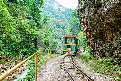 Train runs on narrow-gauge railway in Guam river canyon which is popular tourist landmark and attraction Editorial Stock Photo