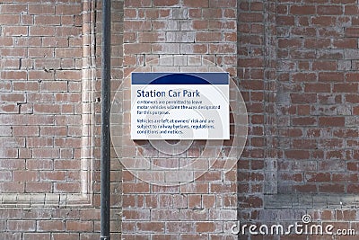Train station car park sign brick wall railway facilities Stock Photo