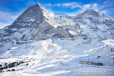 Train in swiss ski alpine mountain resort under Eiger peak, Grindelwald, Switzerland Stock Photo