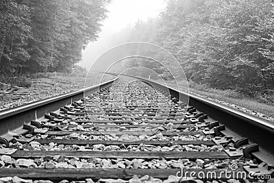 Train track into the fog Stock Photo