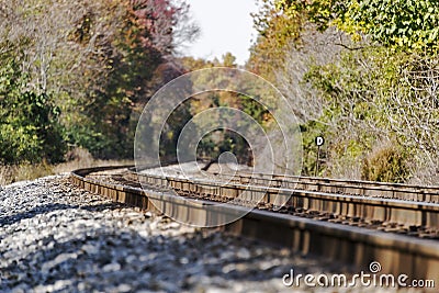 Train tracks disappearing into a rural autumn landscape Stock Photo