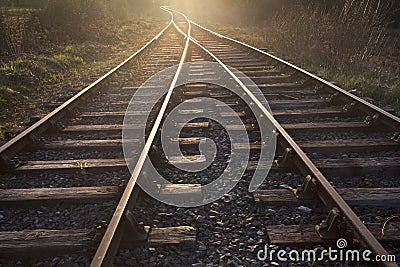 Train tracks leading to the sunset Stock Photo