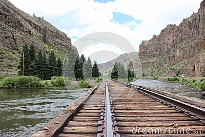 Train tracks running through the mountains Stock Photo