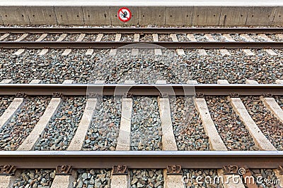 Train tracks at train station with crossing forbidden sign in Ra Stock Photo