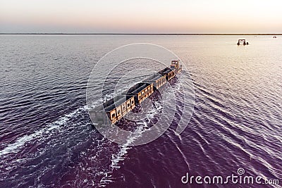 train travels from water. Mined salt in Lake Burlin. Altai. Russia. Bursolith. Old train rides on the railway laid in the water Stock Photo