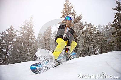 Snowboarder girl in action on ski-run Stock Photo