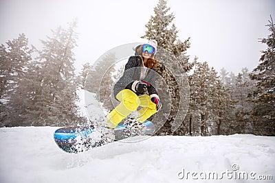 Trained woman snowboarding Stock Photo