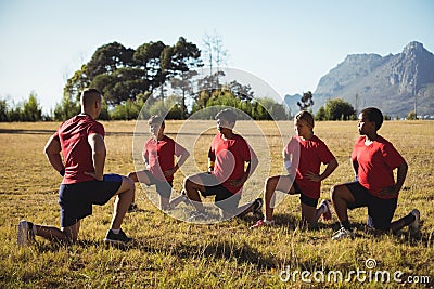 Trainer instructing kids while exercising in the boot camp Stock Photo