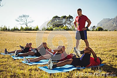 Trainer instructing kids while exercising in the boot camp Stock Photo