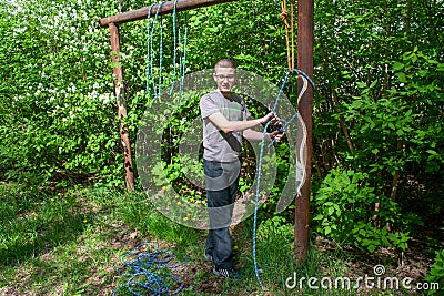 Training in industrial mountaineering. Tying knots on the safety rope. Stock Photo