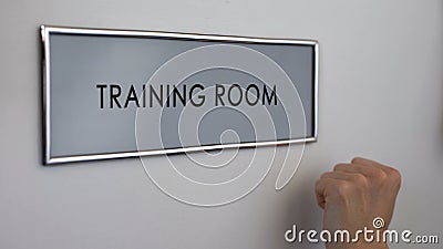 Training room door, hand knocking closeup, business conference, company seminar Stock Photo