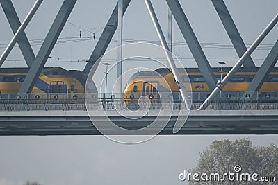 Trains passing each other on a bridge in Nijmegen, Netherlands Editorial Stock Photo