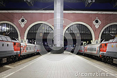 Trains at the train station waiting for passengers to board. Travel by rail on vacation Editorial Stock Photo