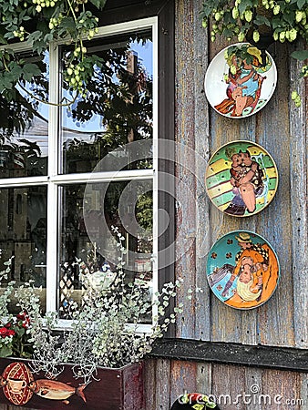 Painting couple lover artwork on ceramic plates decorating shop walls on the lakefront around the Trakai Island Castle in Trakai, Editorial Stock Photo