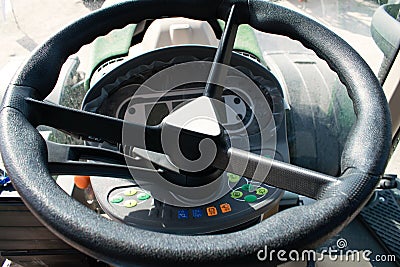 Traktor cabin device. Inside modern tractor. Control panel with buttons, monitor, Steering wheel. View from work place Editorial Stock Photo