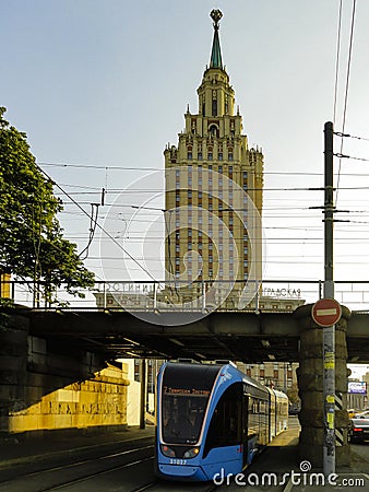 Tram passing under Kalanchevsky viaduct with view of Leningradskaya hotel. Editorial Stock Photo