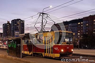 The tram stops in the evening city Editorial Stock Photo