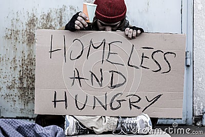 Tramp sitting on the street Stock Photo