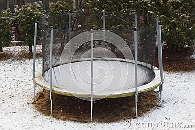 Trampoline with snow at winter time Stock Photo