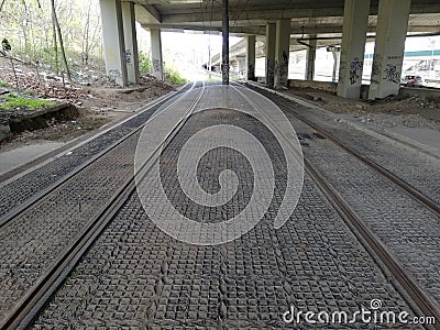 Tramway paralel tracks perspective under a bridge Stock Photo