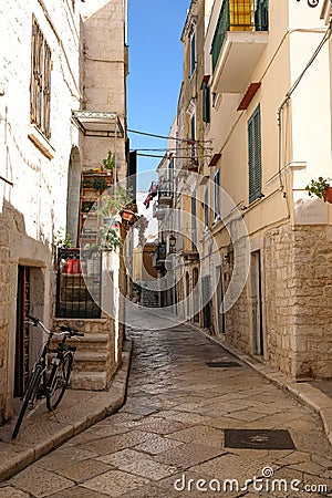 Street scene with bicycle in the foreground, in the Jewish Quarter of the historic medieval town of Trani in Puglia, Italy Editorial Stock Photo