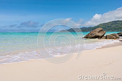 Tranquil bay with white sand, blue skies, granite stones and turquoise sea at Fairyland Beach, Seychelles Africa. Stock Photo