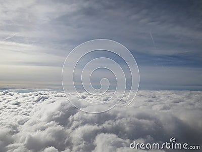 Tranquil Beautiful View From Plane Window at Blue Sky over White Clouds Stock Photo